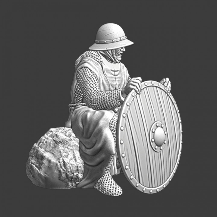 Medieval infantryman sitting with shield at campfire image