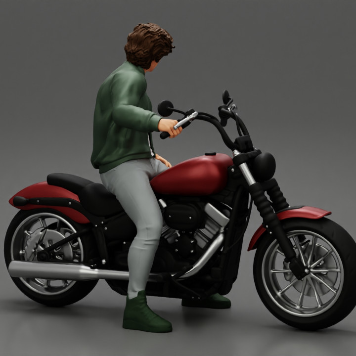 Young man sitting on his motorbike image
