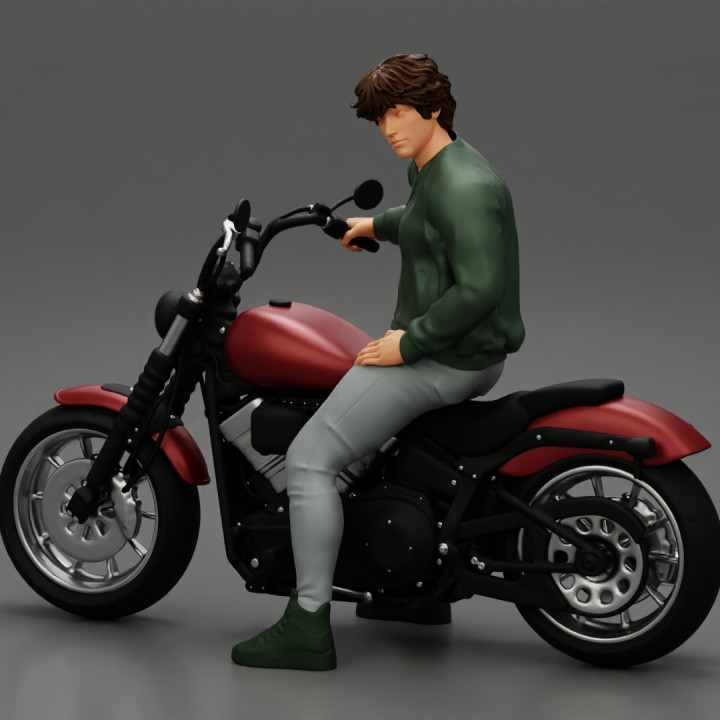 Young man sitting on his motorbike image