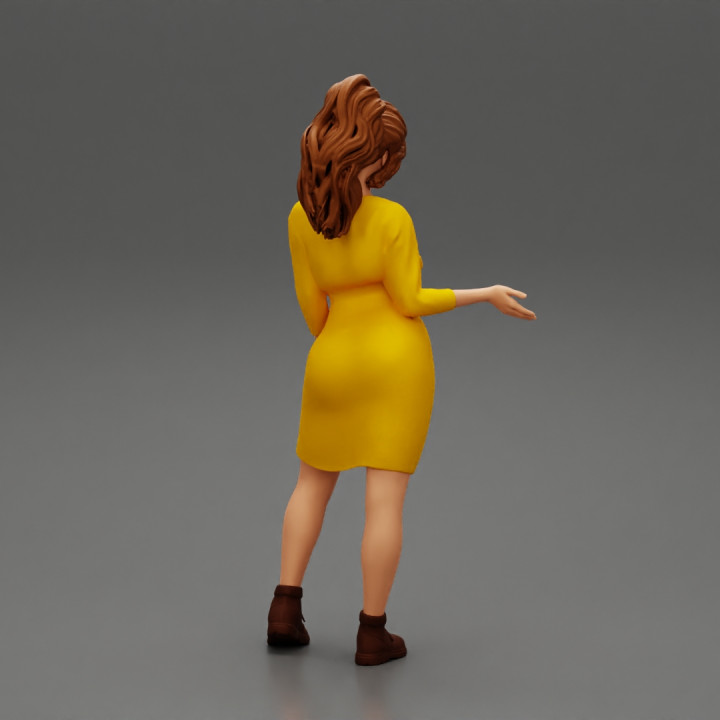 woman explaining pose wearing dress and boot image