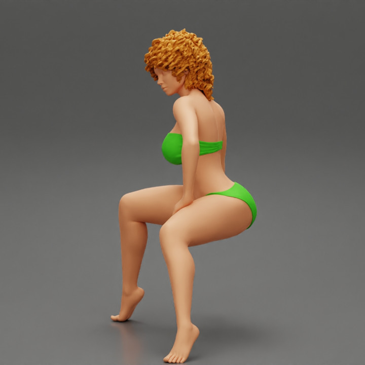 Young Woman Sitting in bikini with Curly Hair image