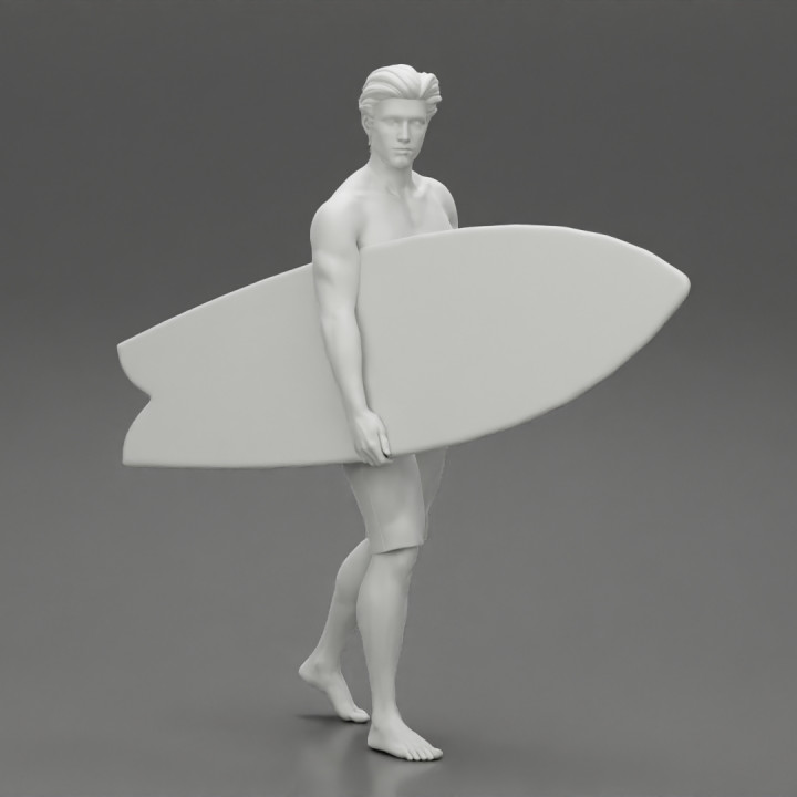 young man holding surfboard walking on the sea