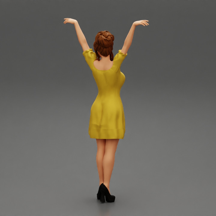 Sexy young girl in a dress raised her hands up image