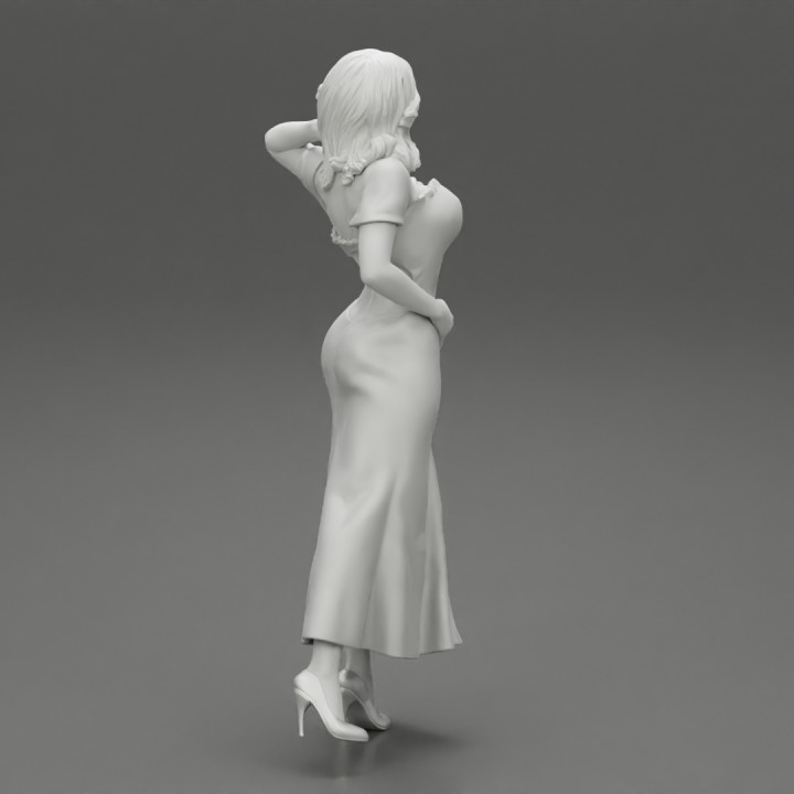 beautiful tanned woman wearing an elegant dress posing standing