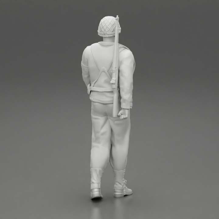 soldier walking carrying a rifle