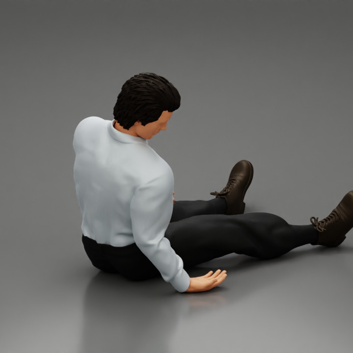 Accident of a male worker sitting on the floor with an injured image
