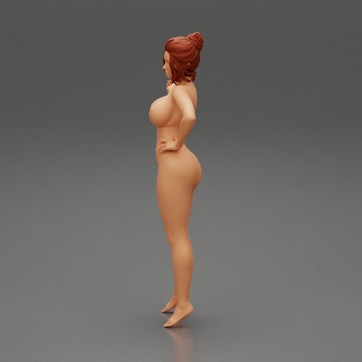 Naked girl standing and put hand on hip image