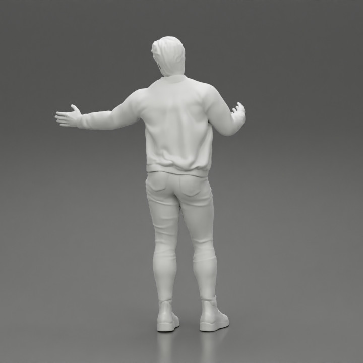 young man standing and explaining with hands image