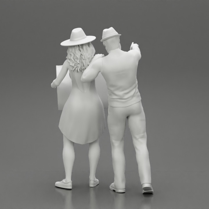 2 models Travel man wearing a hat and a beard pointing  and travel woman holding a map and looking to the map image