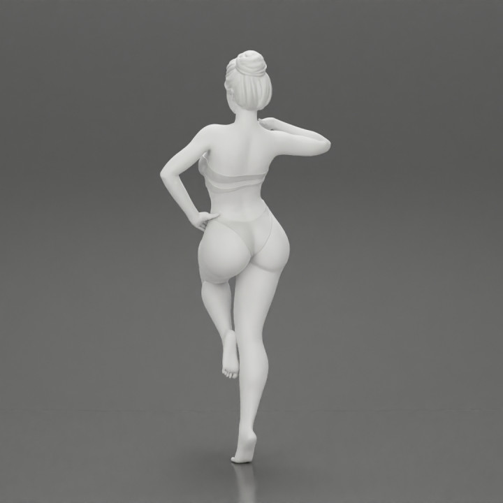 Sexy Woman In bikini posing and Standing On One Leg image