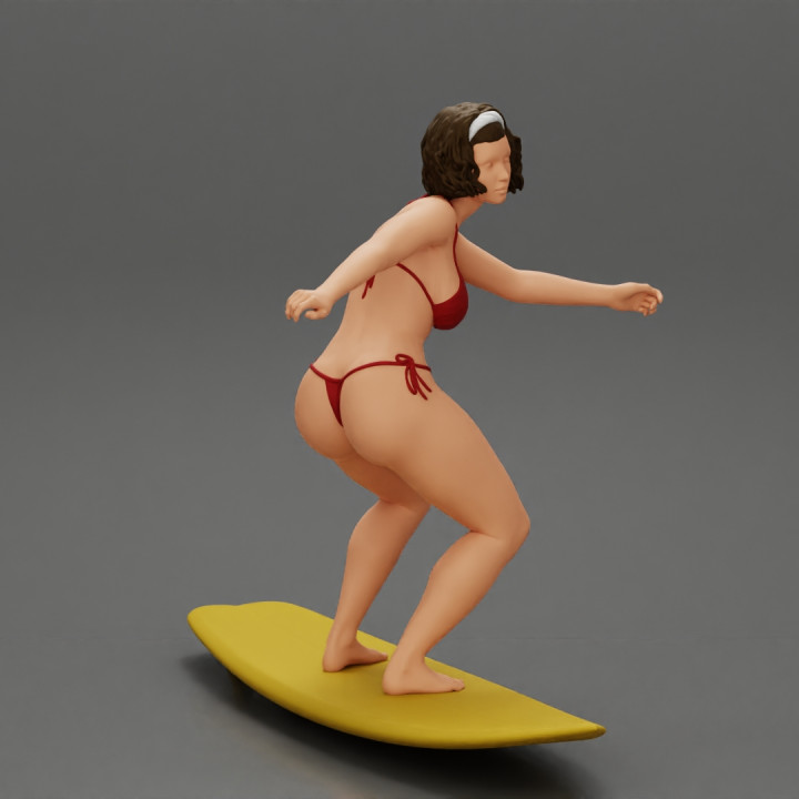 Sexy Girl in A Bikini Swimsuit Riding Wave on board image