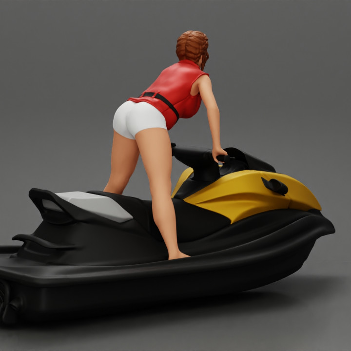Beautiful girl riding standing up on a speeding jetski image