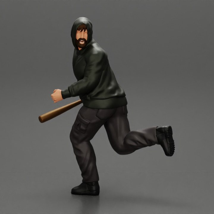 gangster man in hoodie fears running and holds a baseball bat image