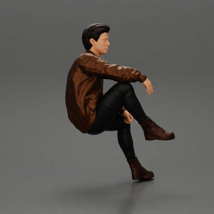 Handsome Young Man in Leather Jacket Looking Away while Sitting image