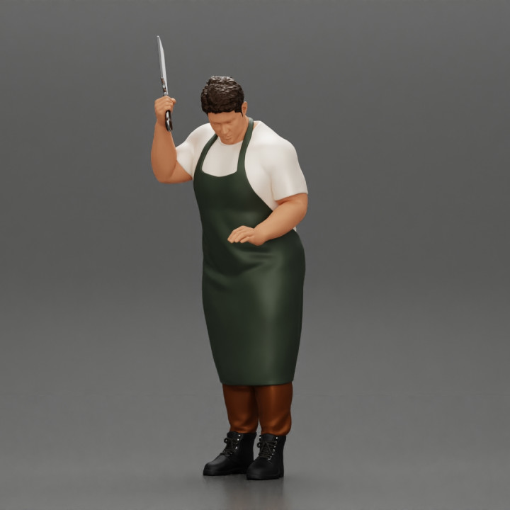 butcher standing while holding a cleaver and cutting something image