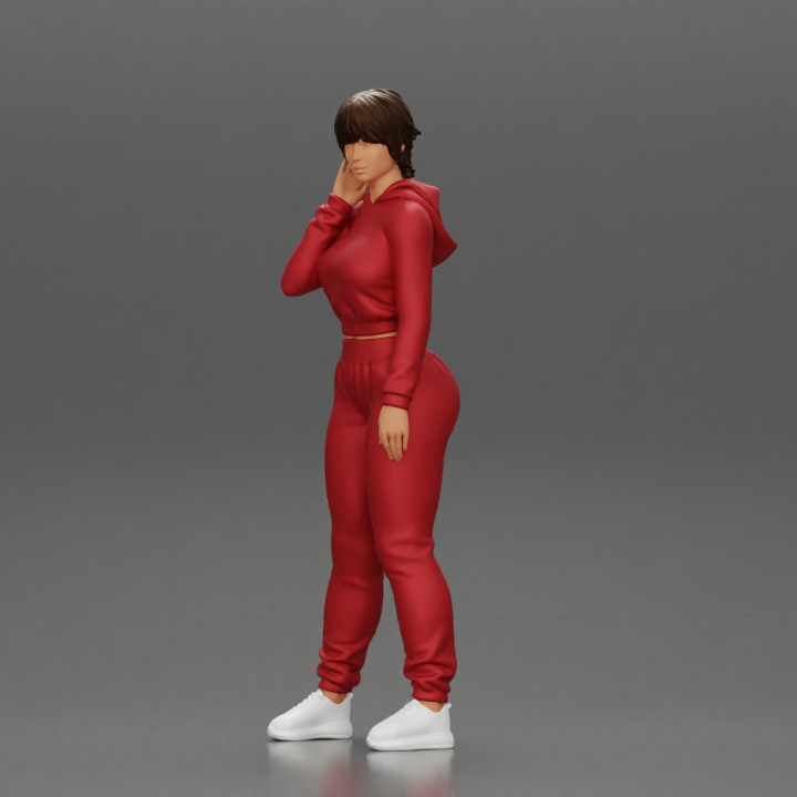 sexy girl in a sports outfit hoodie is standing image