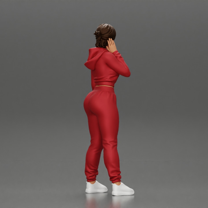 sexy girl in a sports outfit hoodie is standing image