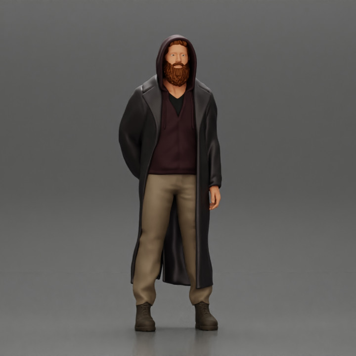 bearded man stands confidently adorned in a stylish hoodie and a flowing long coat image