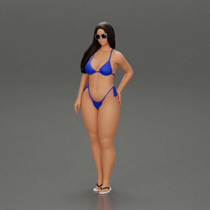 sexy girl in a bikini and sandals with sunglasses  standing putting her left hand on her hip image