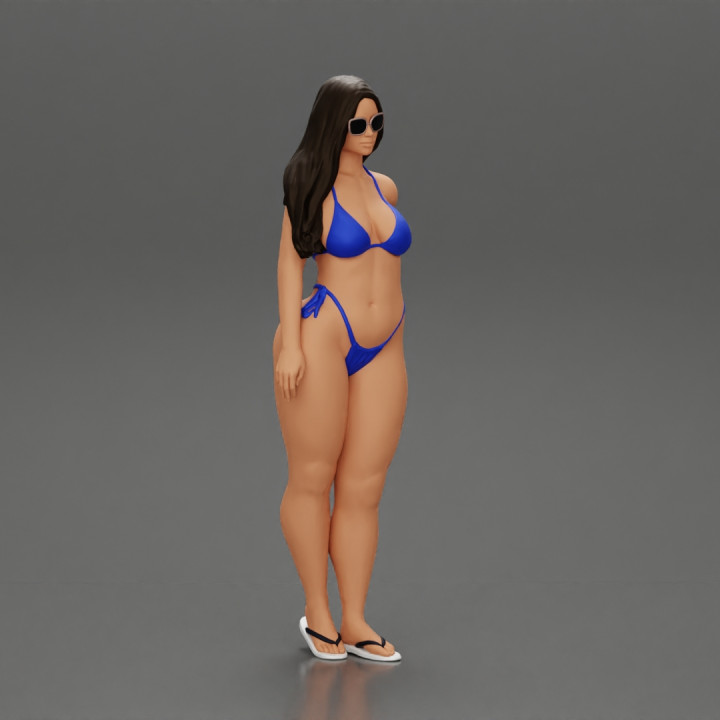 sexy girl in a bikini and sandals with sunglasses  standing putting her left hand on her hip image