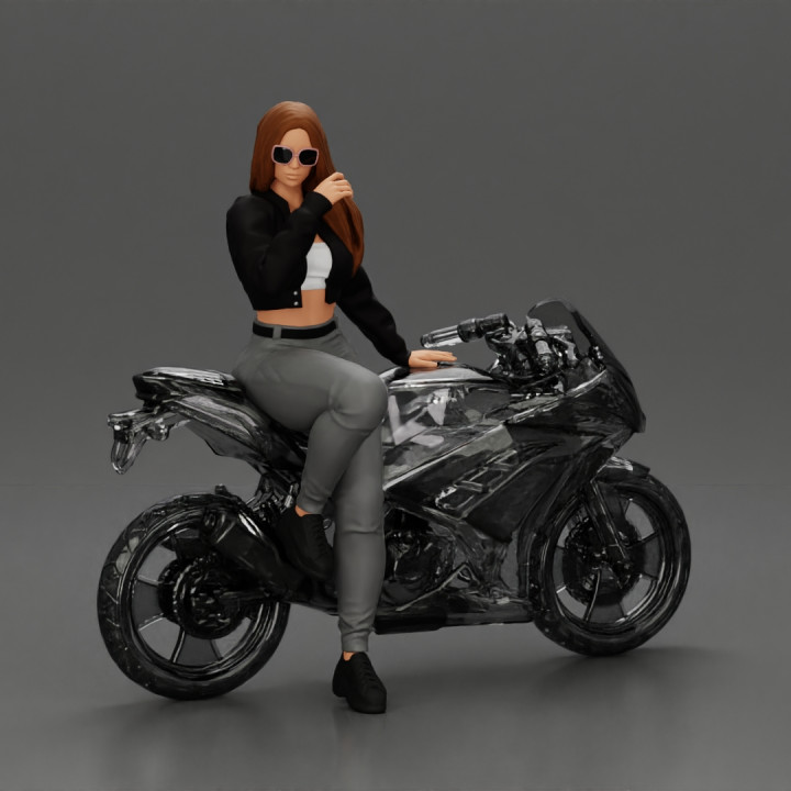 Beautiful girl in sunglasses and  mini jacket sitting on the motorbike image