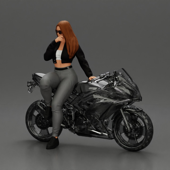 Beautiful girl in sunglasses and  mini jacket sitting on the motorbike image