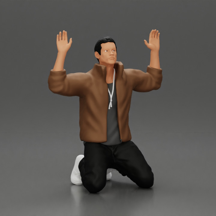 Asian gangster man in jacket sitting with his hands up ready to be arrested image