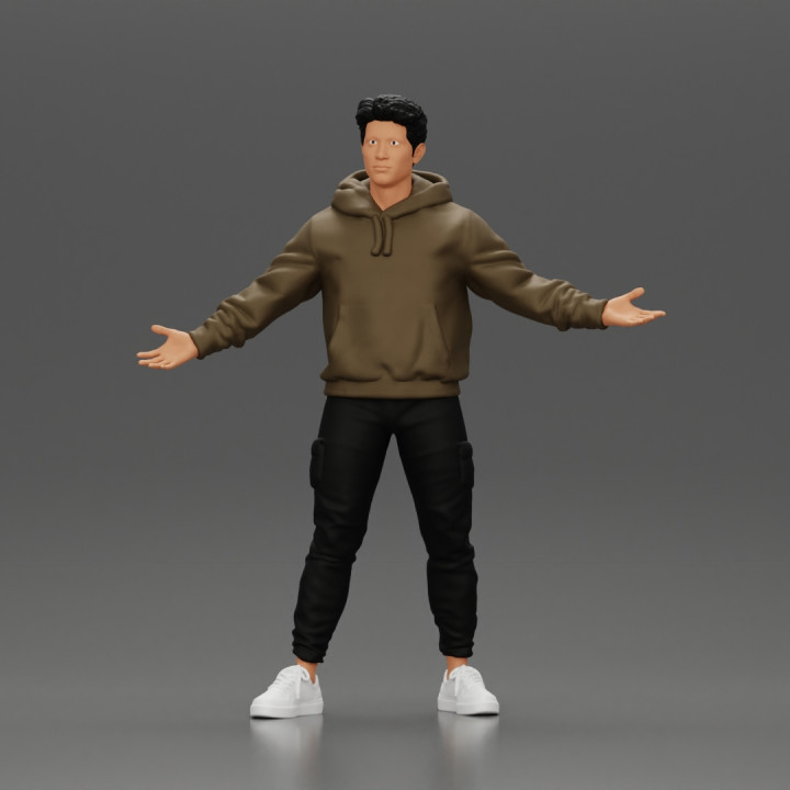 Asian Man Standing in Hoodie with Raised Hands image