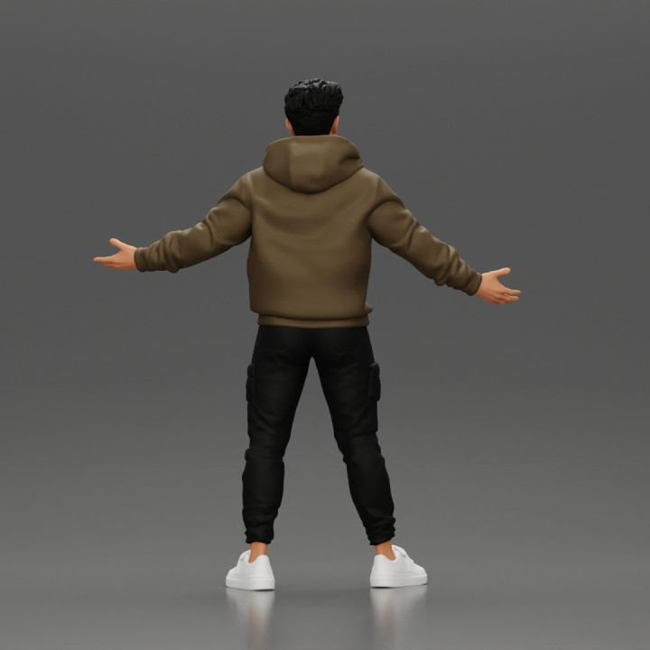 Asian Man Standing in Hoodie with Raised Hands image