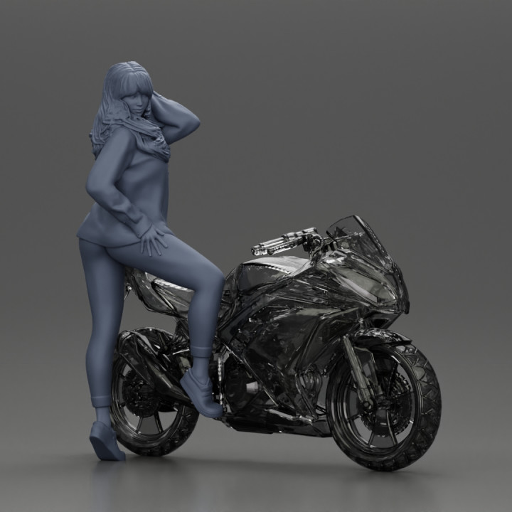 Young woman in  shirt with long hair posing with one foot resting on the motorcycle image