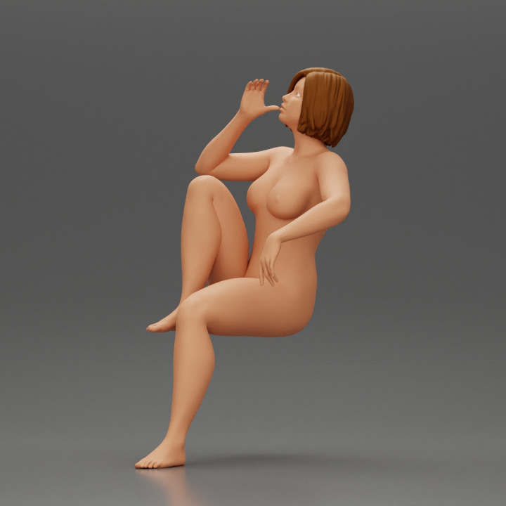 naked woman sitting on a chair hugging her pulled-up leg while drinking image