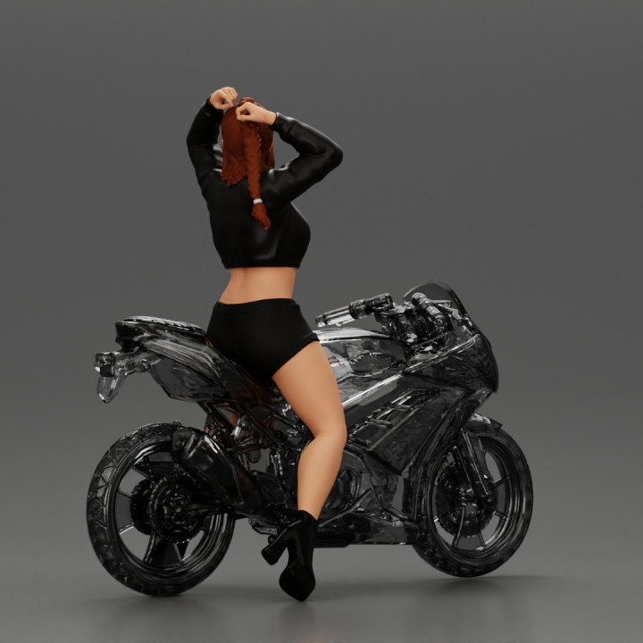 attractive girl on the motorbike stopping and putting hands on hair image