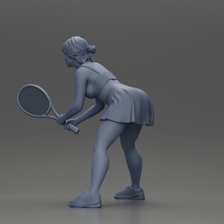 sexy tennis player in skirt holding her racket in a ready position image